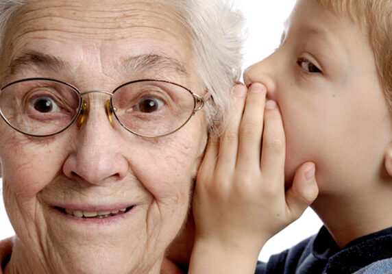 Child Whispering in Grandmother's Ear